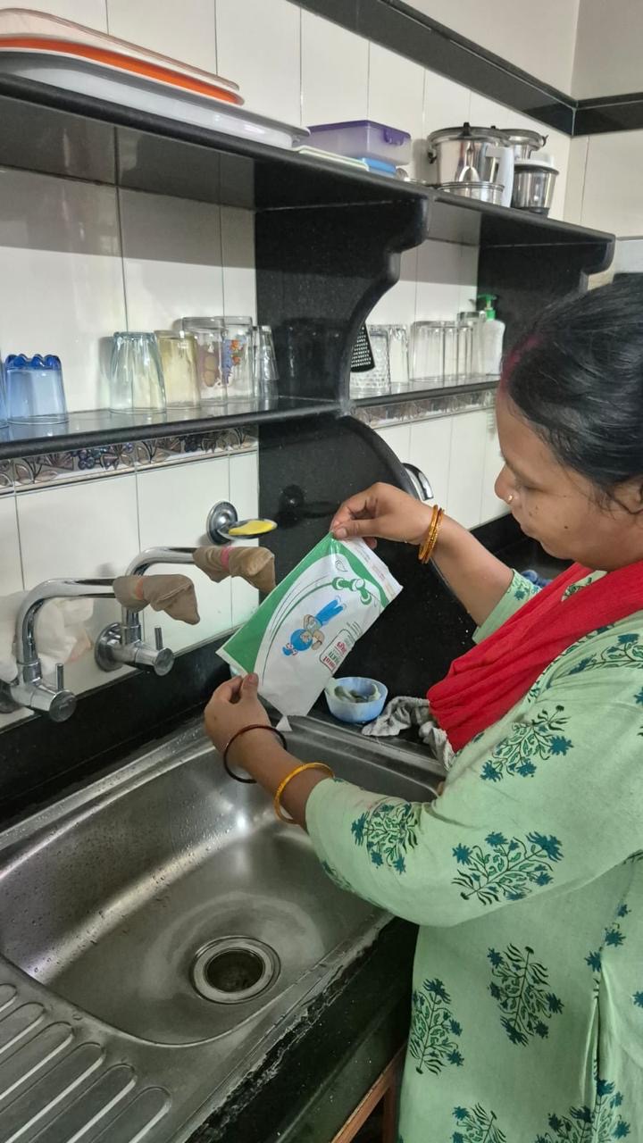 Resident rinsing a milk pouch at home