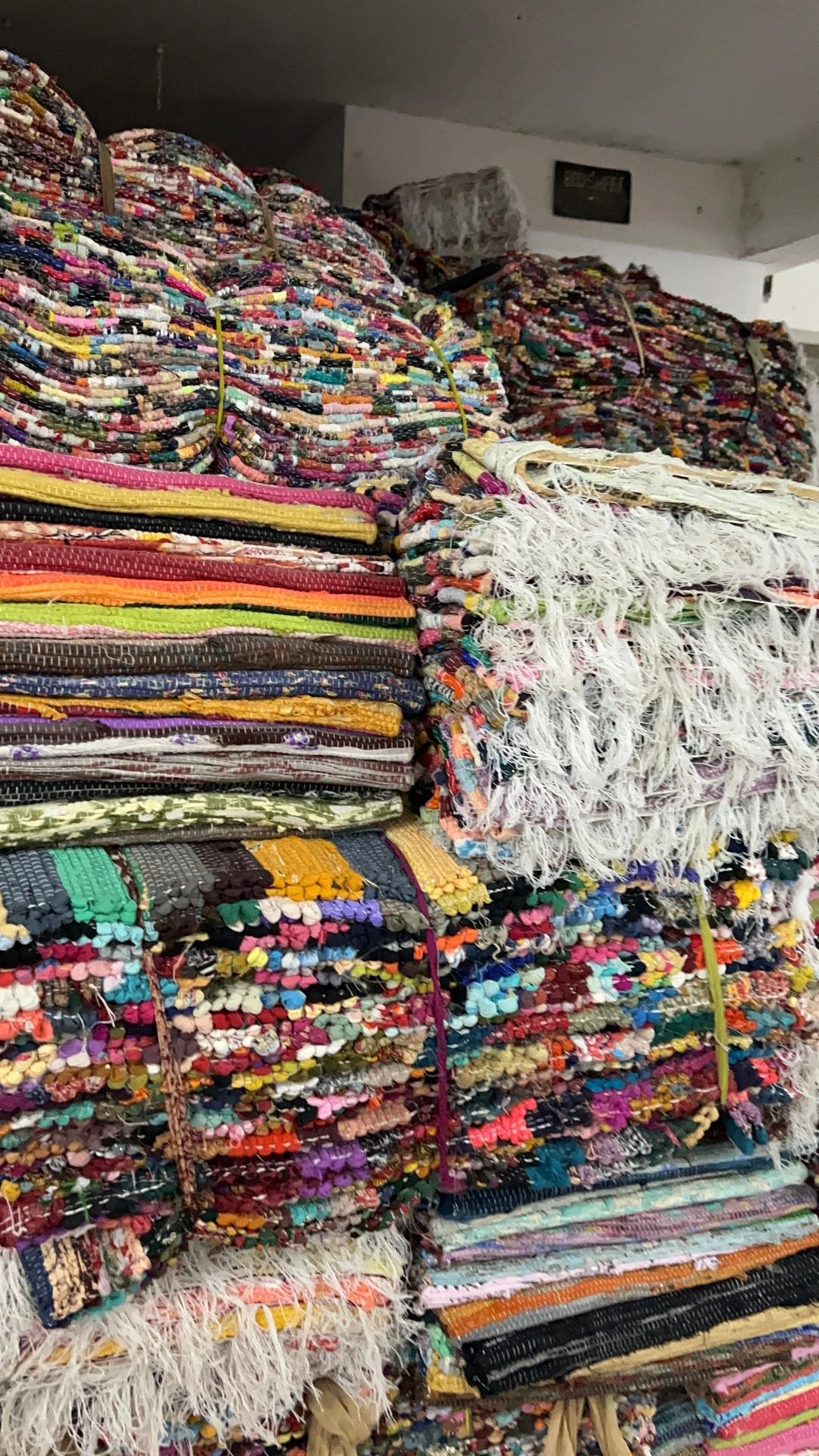 Stacked dharis woven from repurposed sarees at Goonj